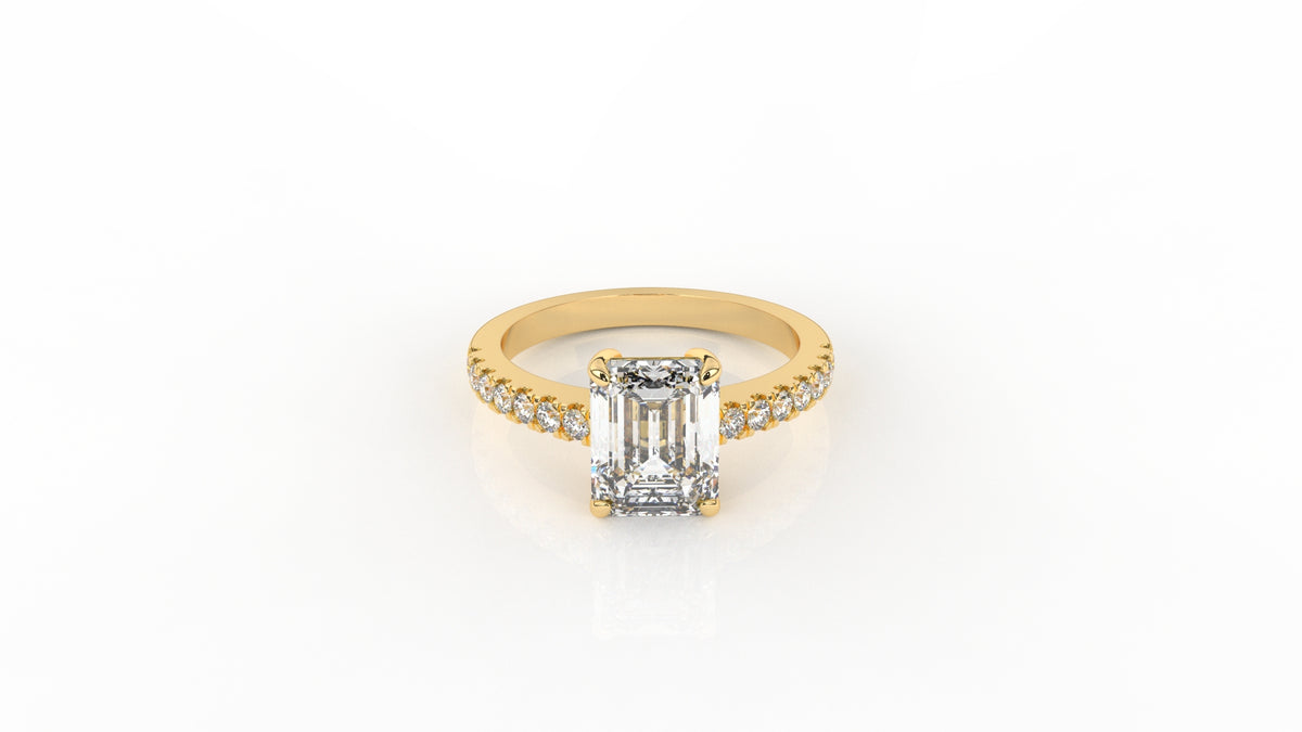 Gold ring with a large diamond and smaller diamonds on the band GLAM NYC
